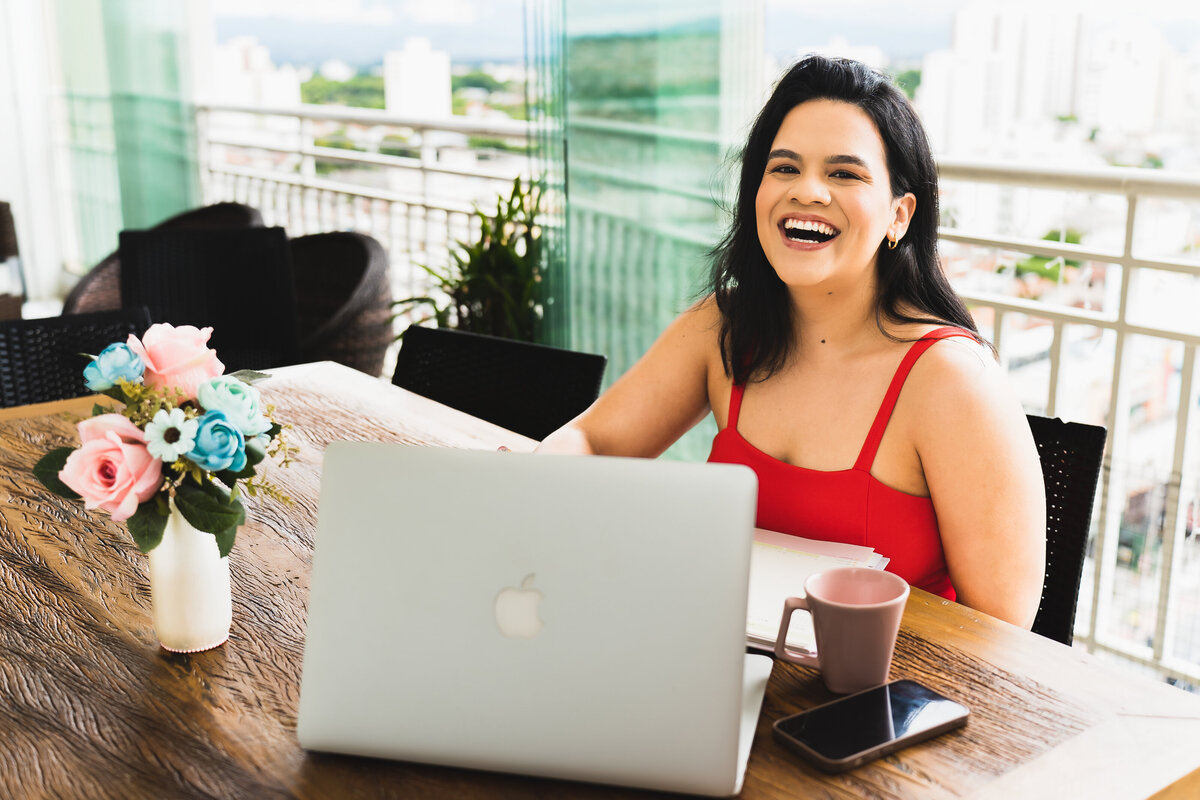 make up artist working on her computer and smiling