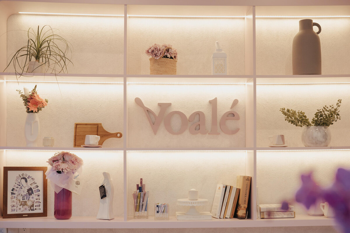 Interior design space showcasing the branding for Voalé, featuring elegant shelving, minimalist packaging elements, and timeless french styling.
