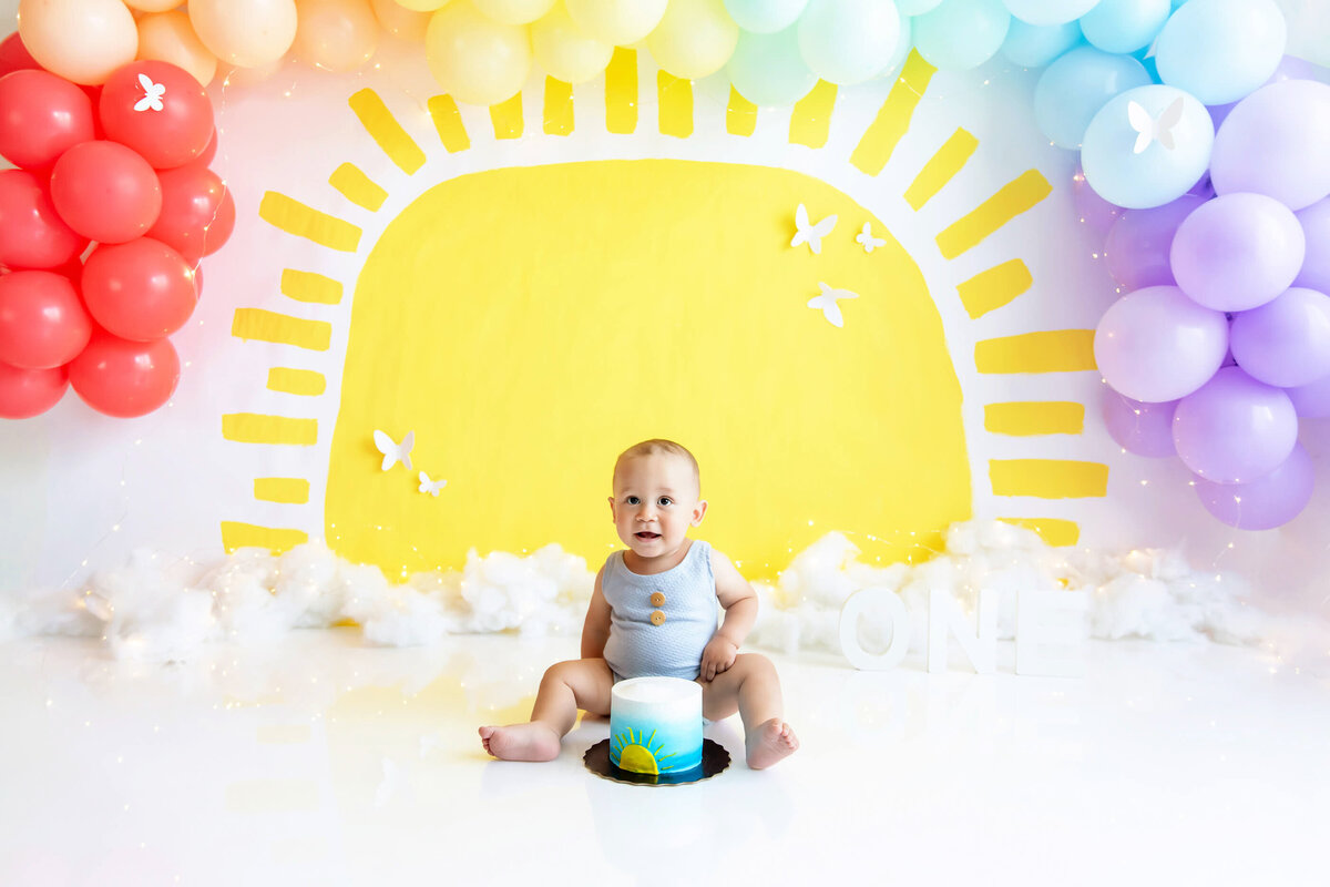 Sun and rainbow cake smash photography session in Burlington, ON