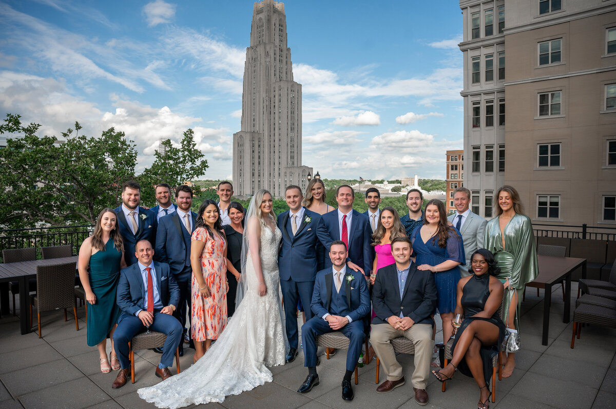 bride and groom with all of their friends on the terrace at university club