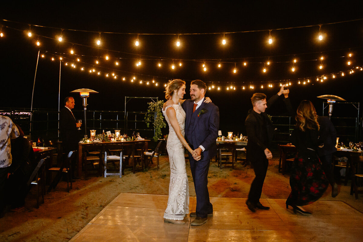 A couple dances on the dance floor at night.