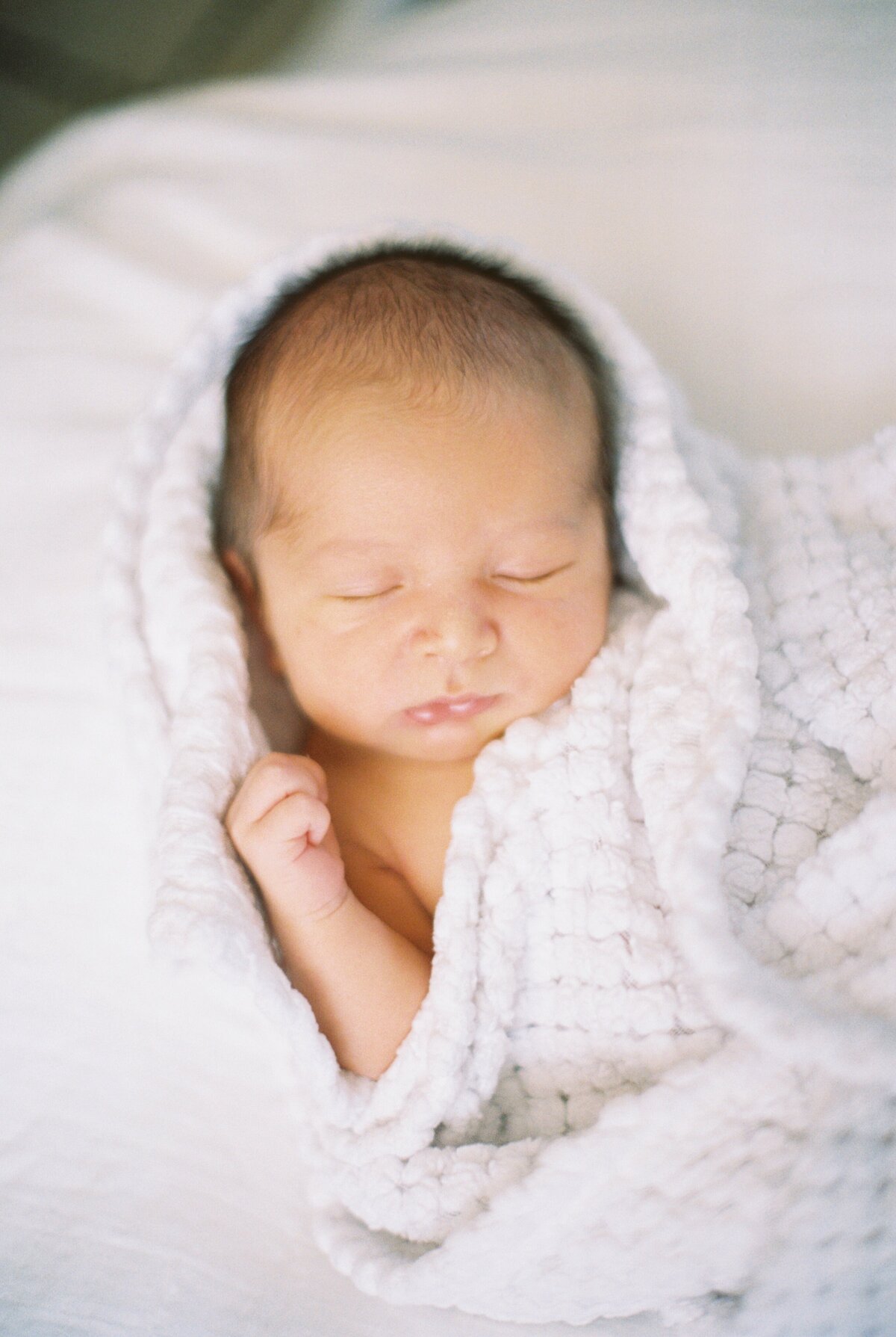 newborn in blanket film photo