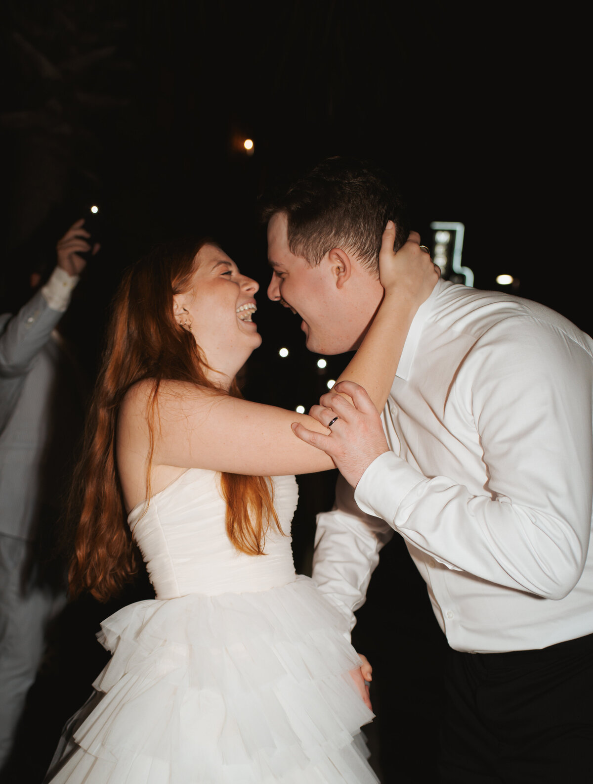 bride and groom exiting to their getaway car