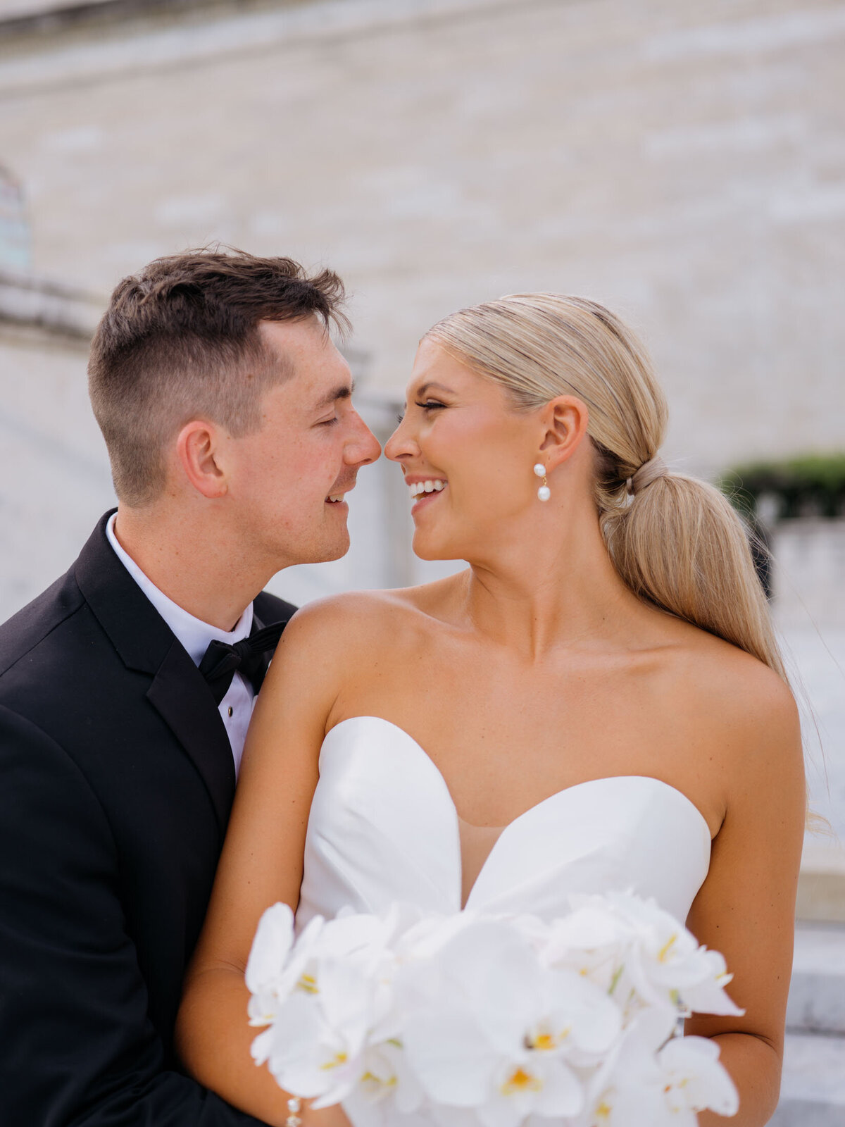 Bride and groom laughing at Cleveland Art Museum
