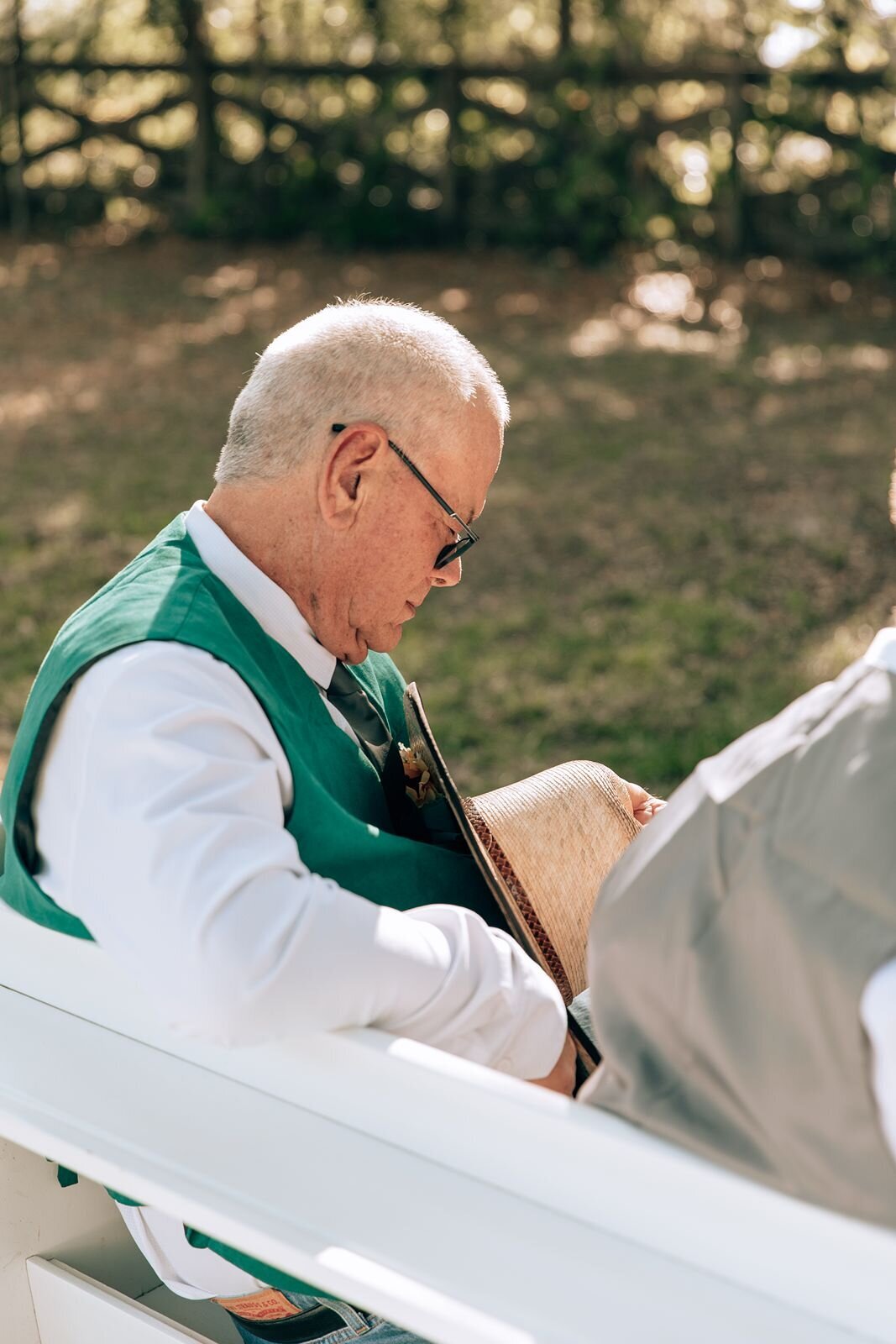 father of the bride prays during wedding ceremony