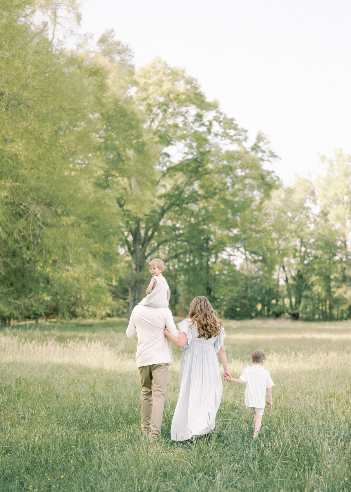 family walking away little boy looking