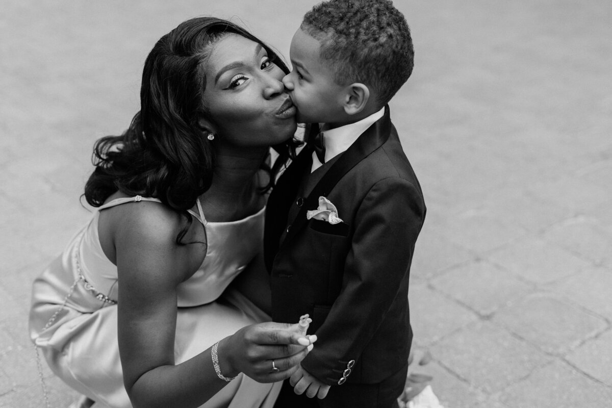 Bride's son give her a little kiss to celebrate the bride's marriage