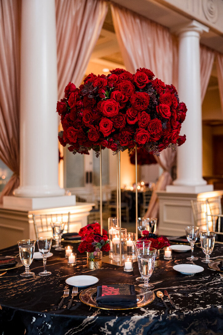 Floating candles, Tall arrangement, gold stand, cocktail arrangements, black and gold linens, red roses, garden roses, champagne drapery, golf club 