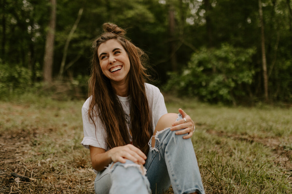 woman sitting on ground smiling