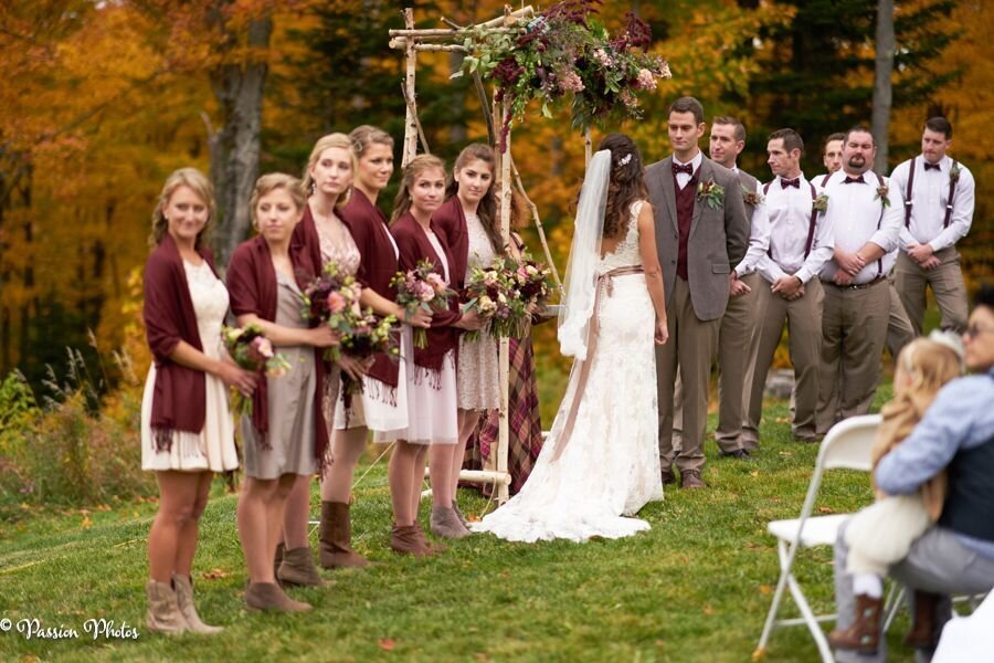 The couple exchanges vows during their outdoor wedding ceremony, surrounded by a picturesque natural setting. This image captures the intimate and serene moment of their nuptials, highlighting the beauty of the outdoor venue and the couple’s love and commitment.