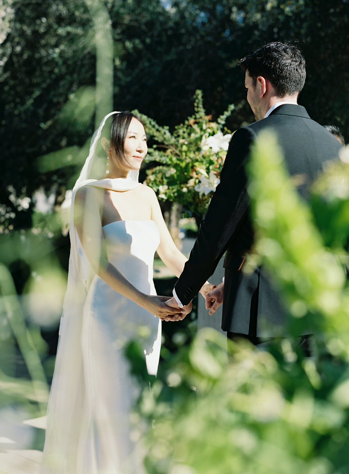 bride-groom-romantic-kiss-wedding-moment-napa-outdoor-flowers