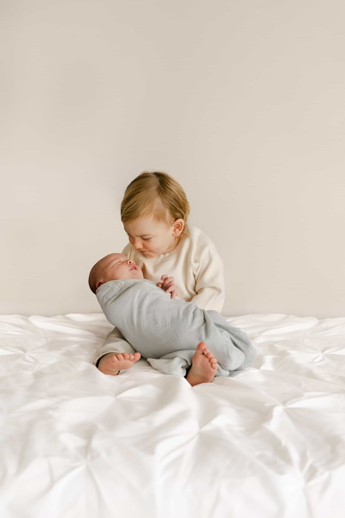 Orange County Newborn Photographer -big brother holding newborn baby brother