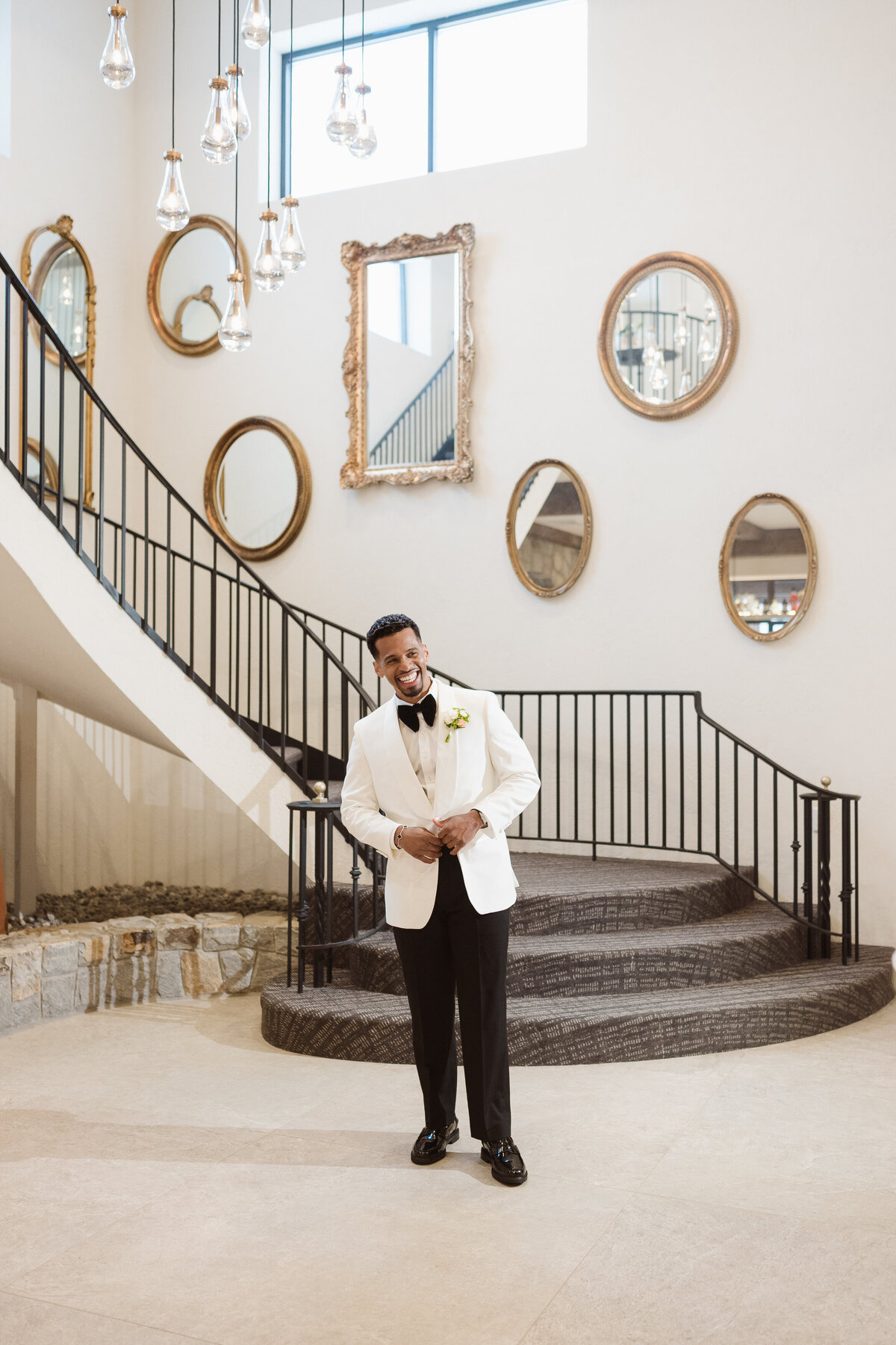 groom waiting for bride at staircase at the perona farms the reserve