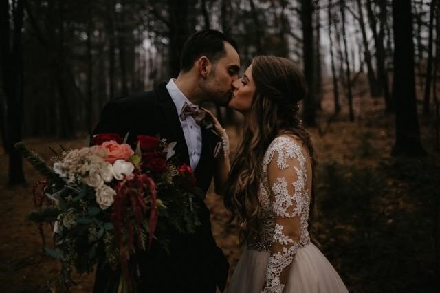 Moody tones, half up/ half down hair styling, lace wedding dress in the woods at dusk
