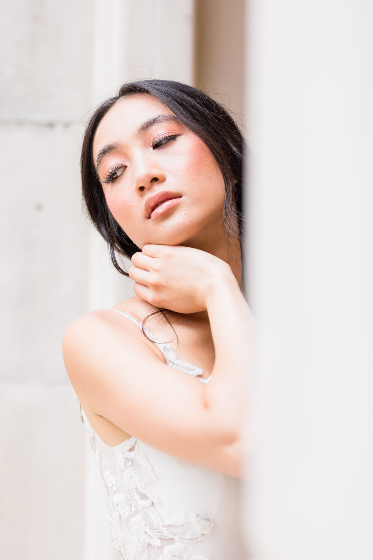 Light and Airy Bride poses in her wedding dress