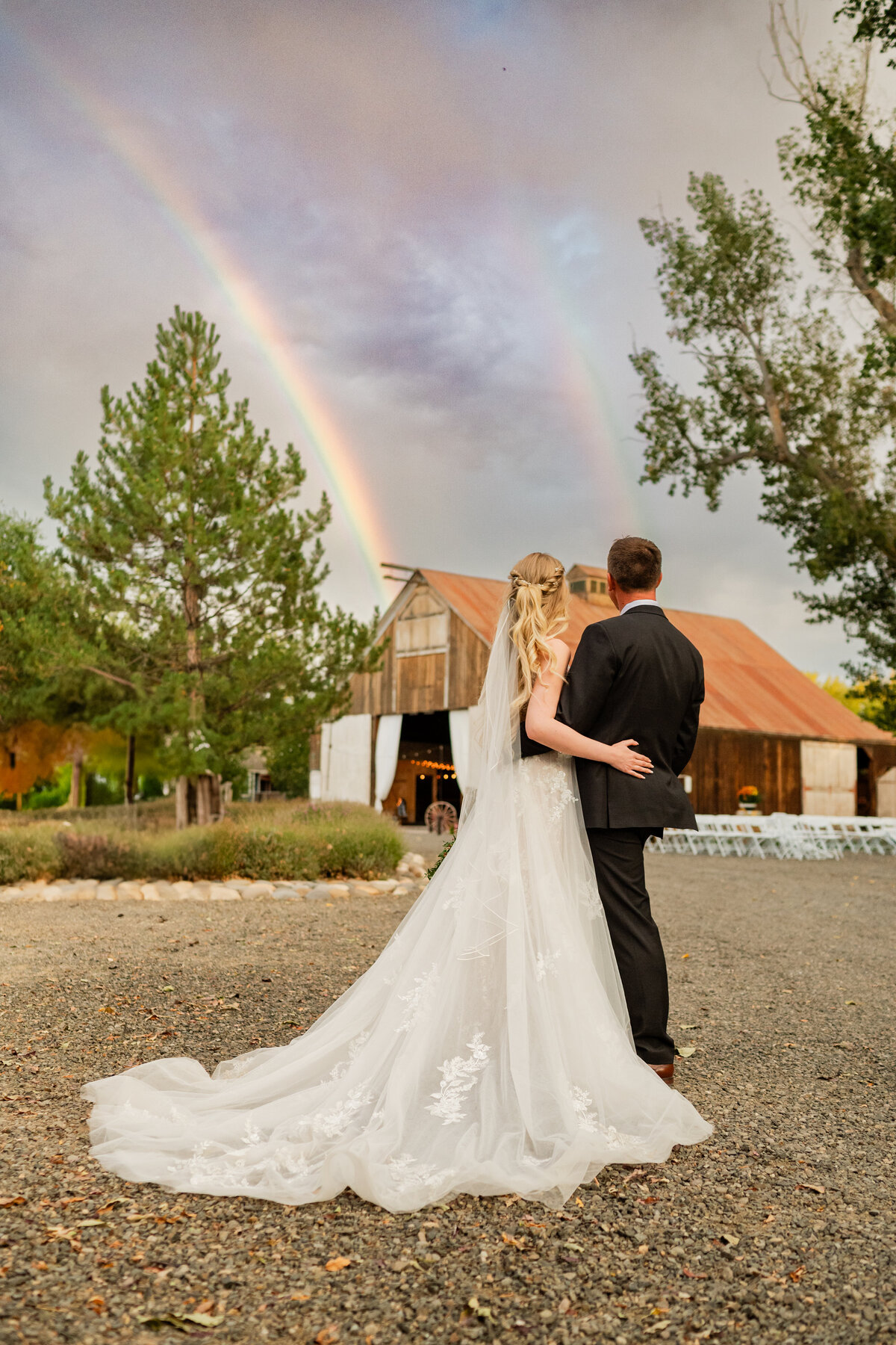 A couple portrait under a rainbow at Jacob's Berry Farm in Minden, Nevada