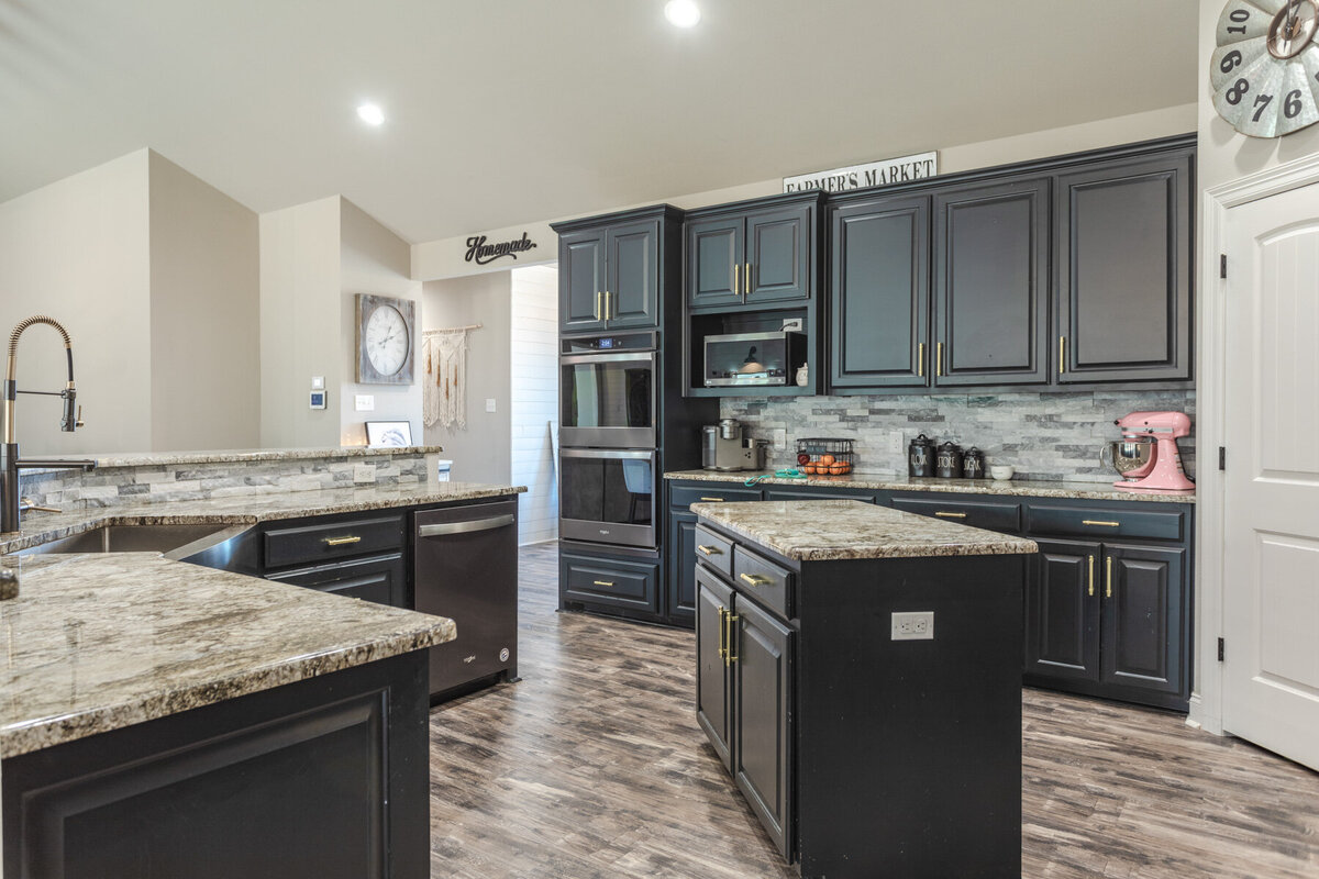 Fully stocked kitchen with island in this five-bedroom, 3-bathroom vacation rental house for up to 10 guests with free wifi, private parking, outdoor games and seating, and bbq grill on 2 acres of land near Waco, TX.