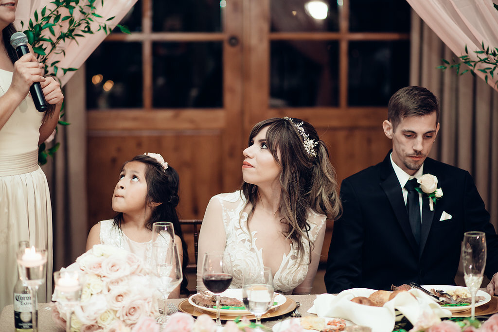 Wedding Photograph Of Bride And Child Looking Up While  Seated Los Angeles