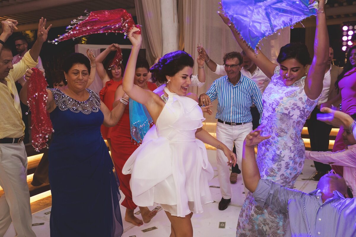 Bride dancing with guests at wedding in Riviera Maya