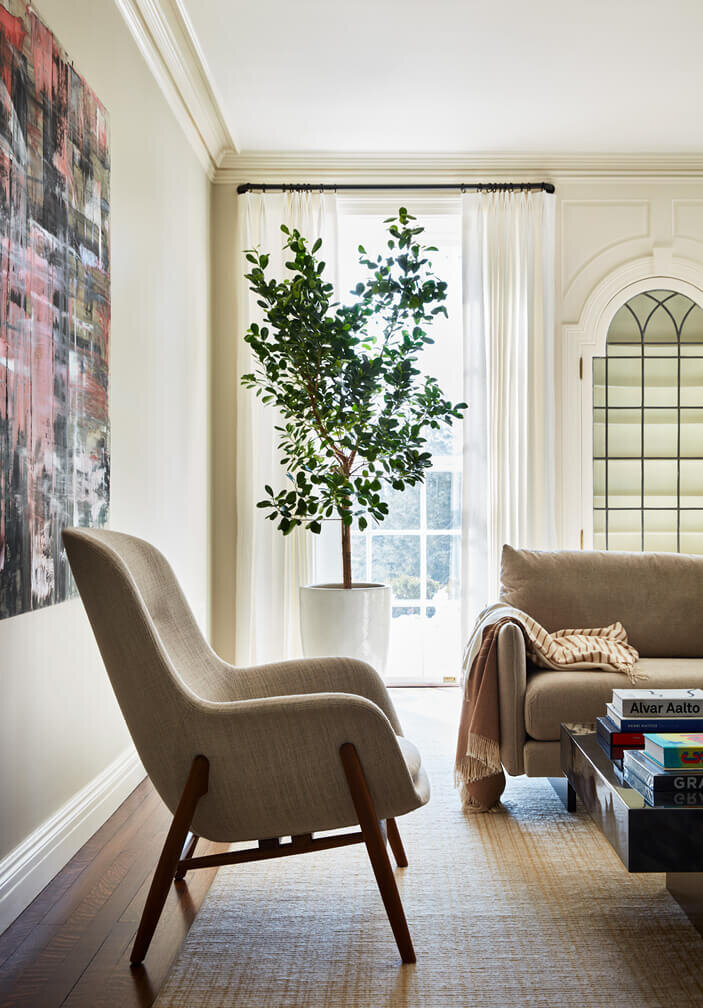 Historic home design in Boston features a Scandinavian living room chair, blending minimalist style with classic architecture for a timeless look.