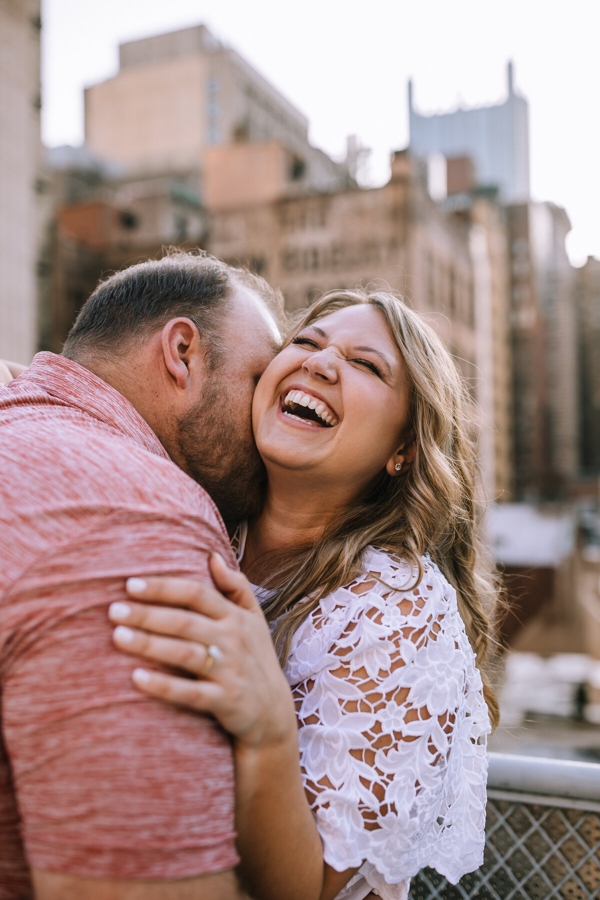 Engaged couple on a rooftop in Downtown Pittsburgh.