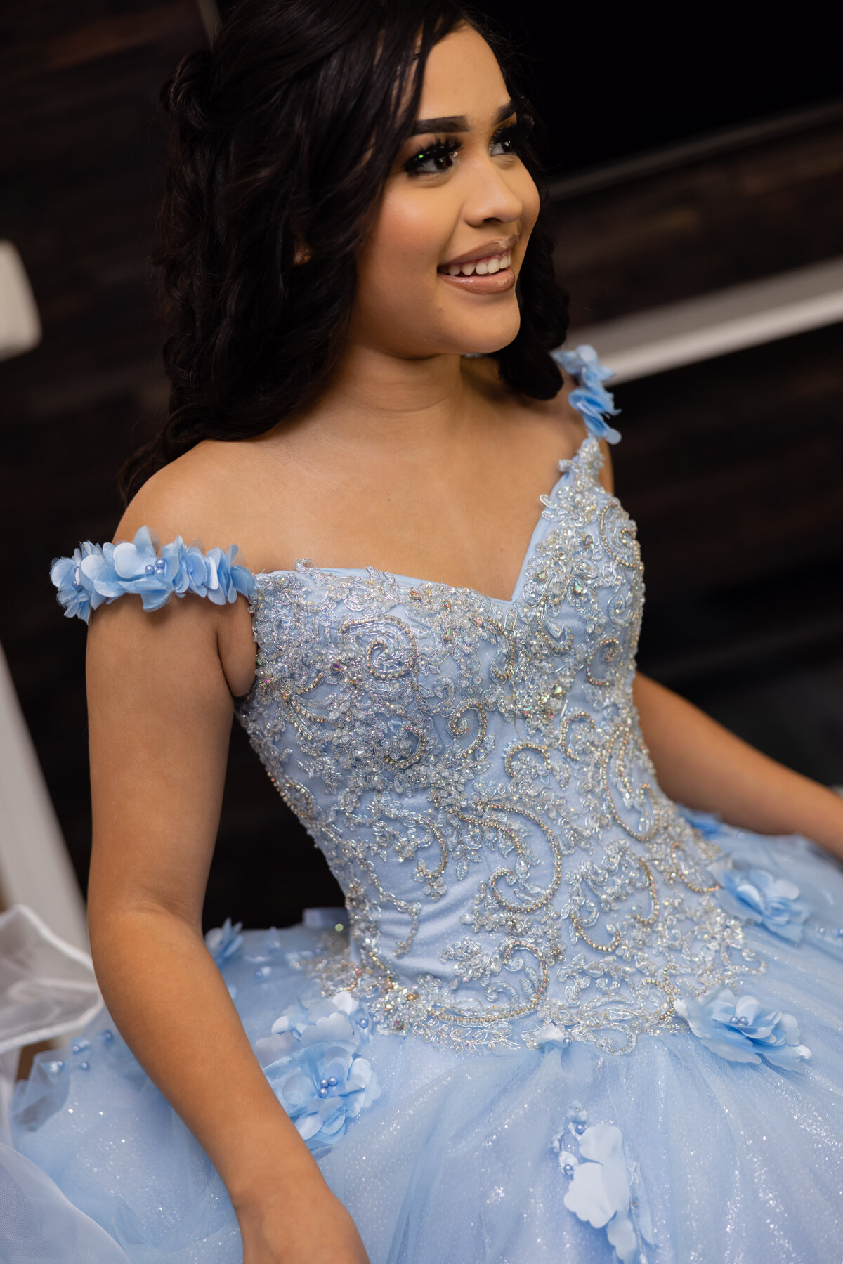 A detailed shot of Victoria’s stunning quinceañera dress displayed beautifully at her home, ready for her special day.