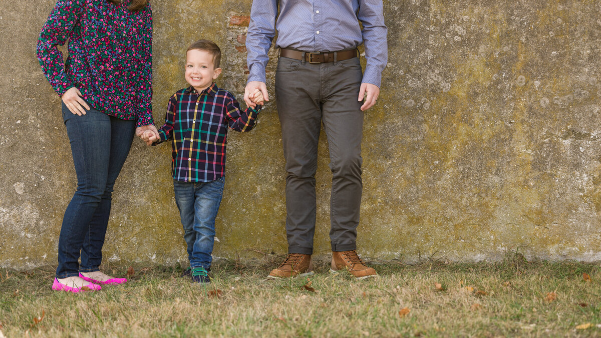 A family captured in a candid walking scene, making lasting memories during an exciting mini photography session in King of Prussia