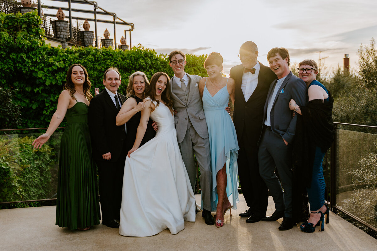 Wedding party posing on terrace with sea view