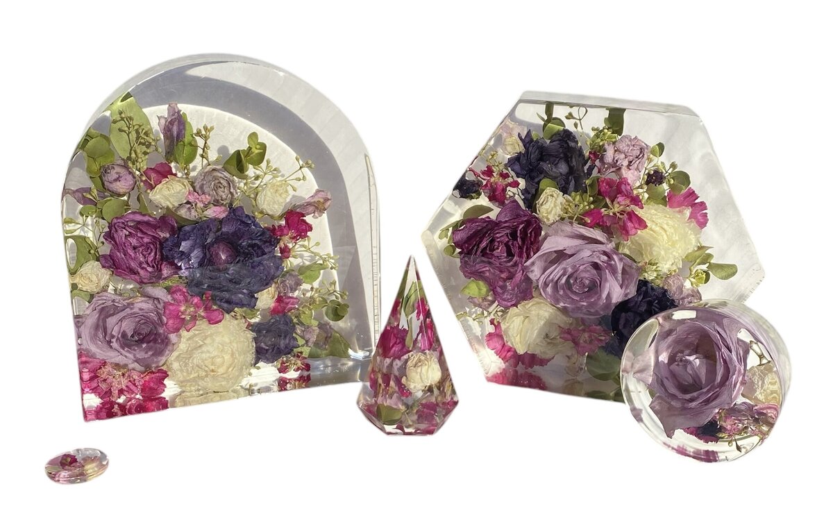hexagon and arch resin blocks with bright pink and purple funeral flowers preserved as a family heirloom