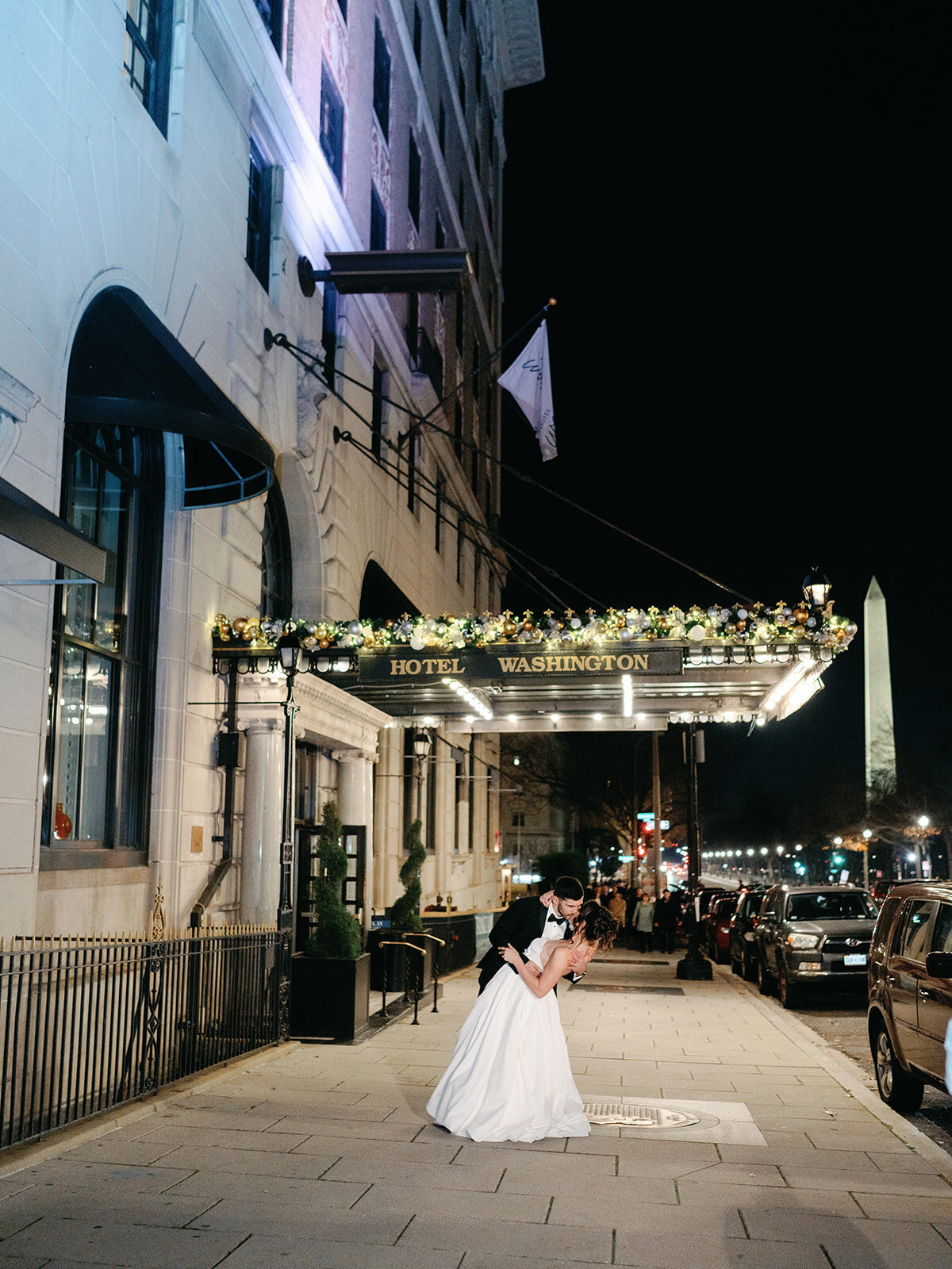 Night shot of couple in front of Hotel Washington 