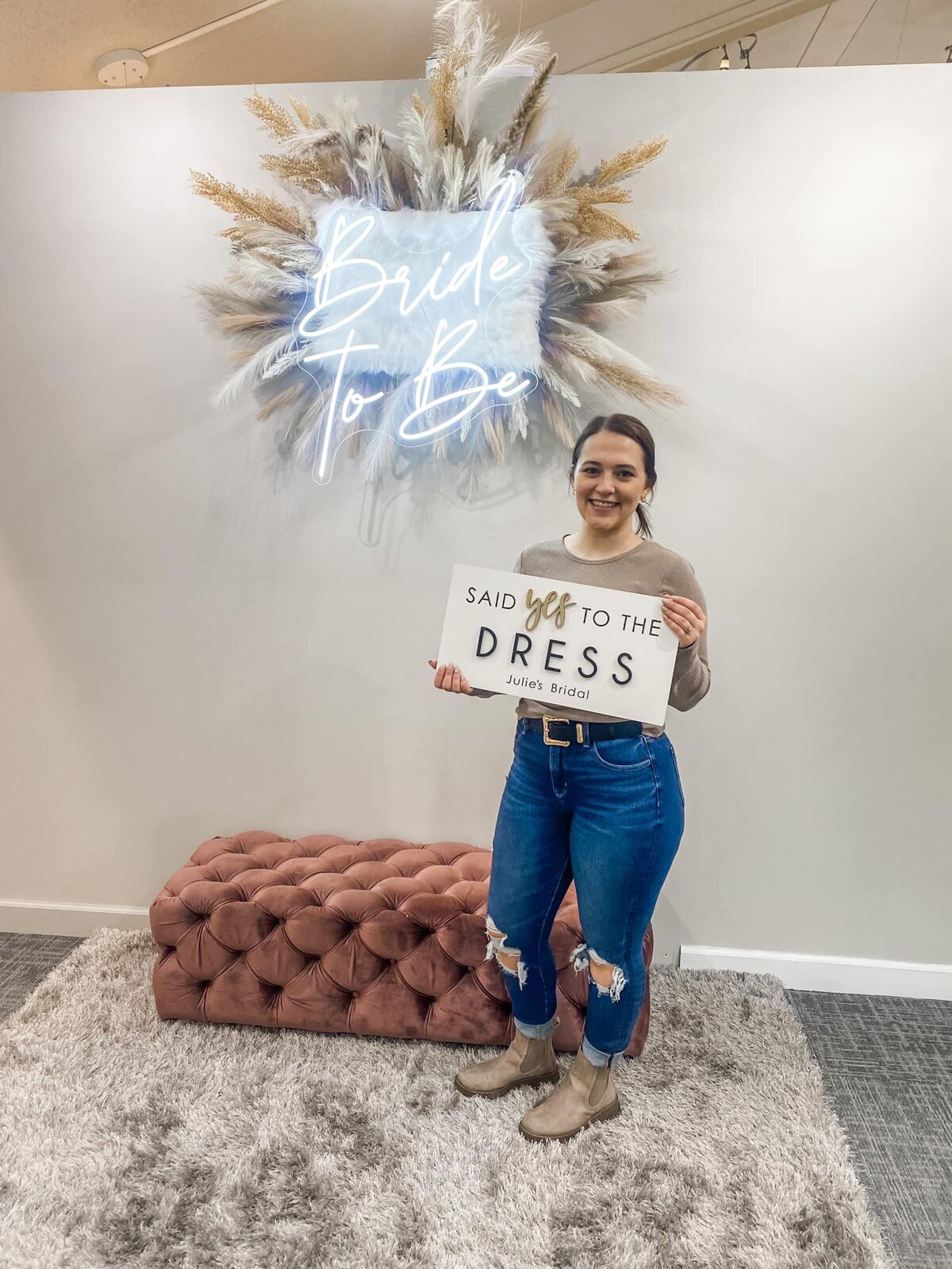 Bride holding said yes to the dress sign at Julie's Bridal in Monroe Wi