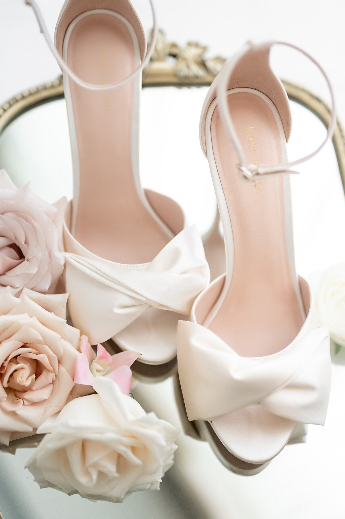 wedding shoes white on mirror with flowers