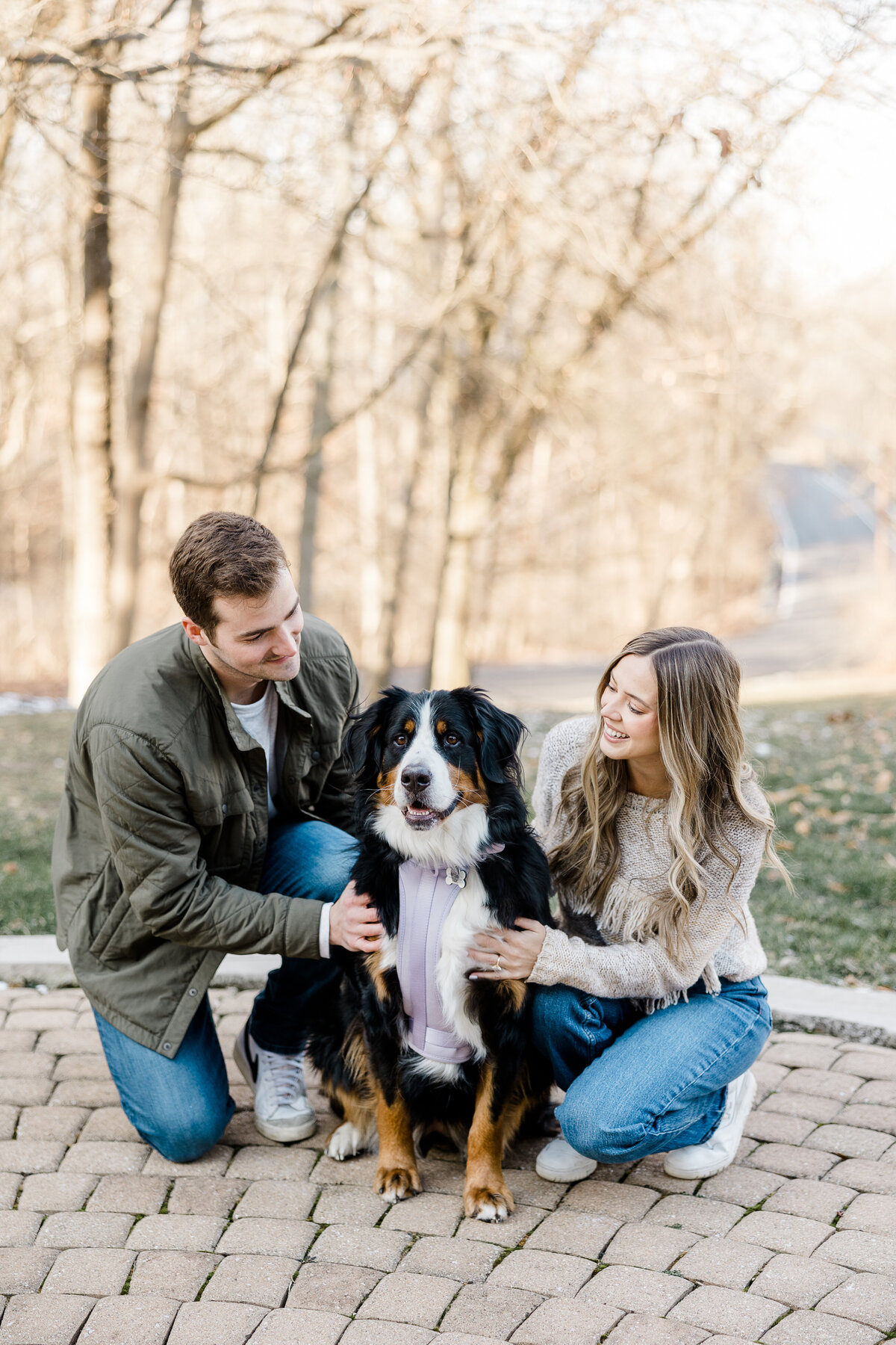 couple posing with their dog during family photos in Indianapolis