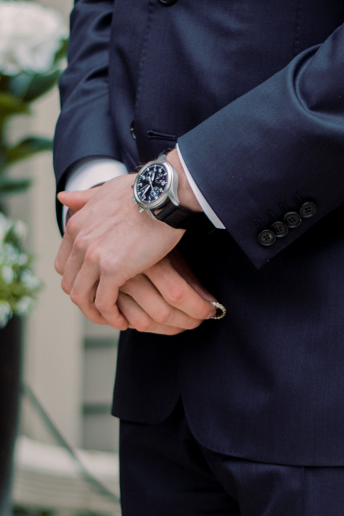 Groom holding wedding ring in his blue suit in oakville ON