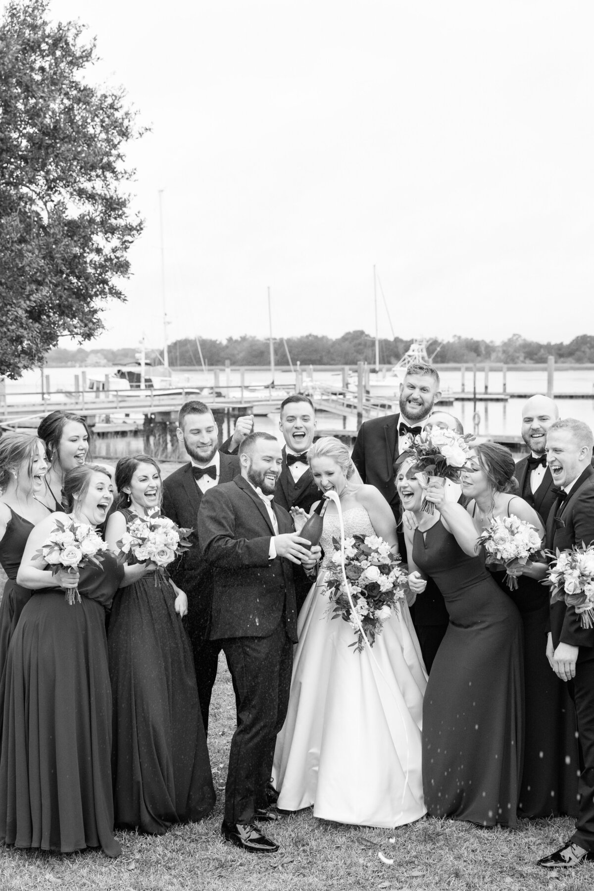 Bridal party celebrating waterfront at a Charleston, SC wedding | Dana Cubbage Weddings