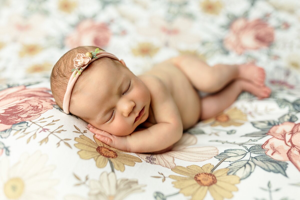 Newborn on floral backdrop in posed newborn studio Harrisonburg VA