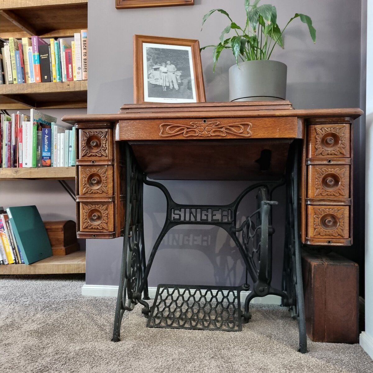Restored antique wooden Singer sewing machine with treadle