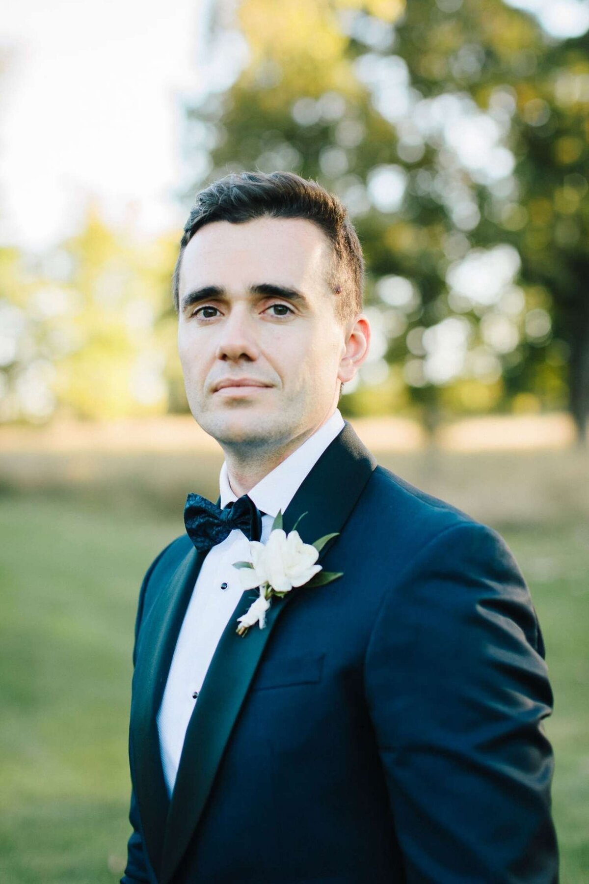 A Groom's Portrait Outdoors at a Luxury Michigan Lakefront Golf Club Wedding