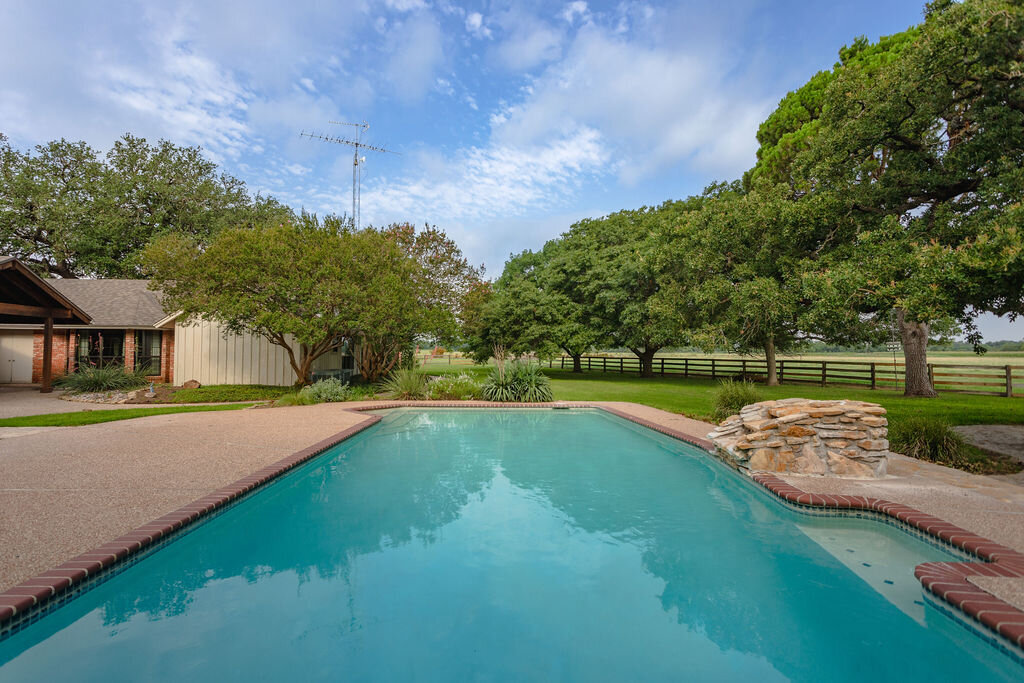 Large outdoor swimming pool at this 5-bedroom, 4-bathroom vacation rental house for 16+ guests with pool, free wifi, guesthouse and game room just 20 minutes away from downtown Waco, TX.