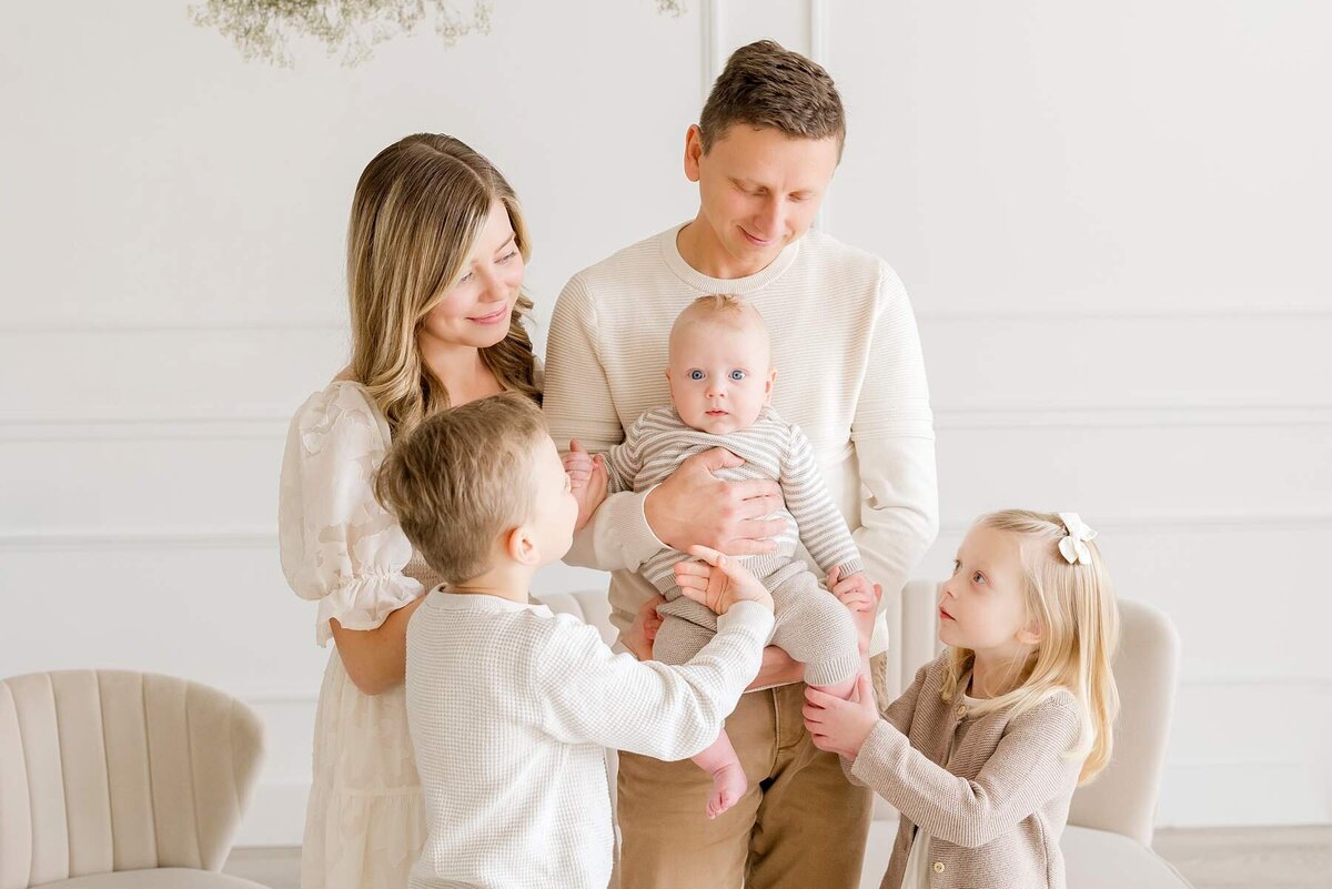 white studio where family poses for family pictures
