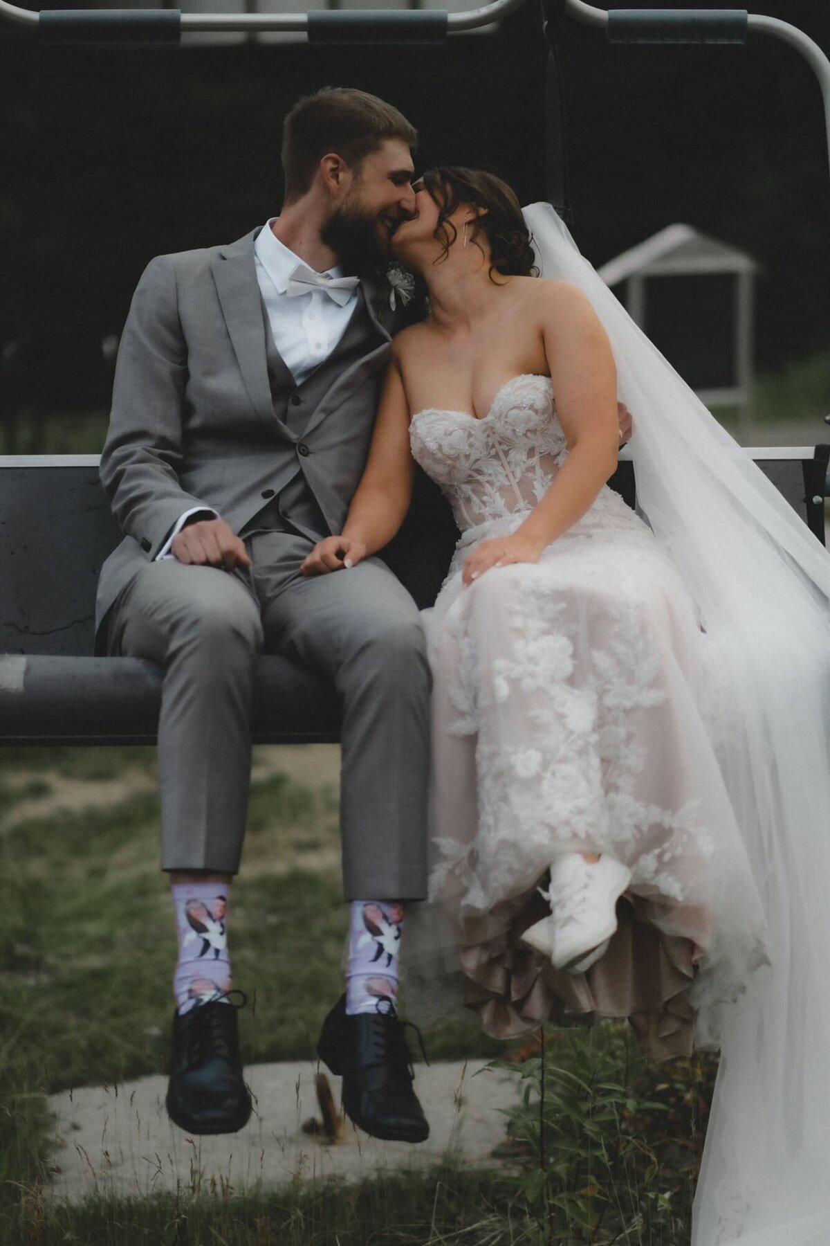 Wedding couple kiss and sit on a chair lift