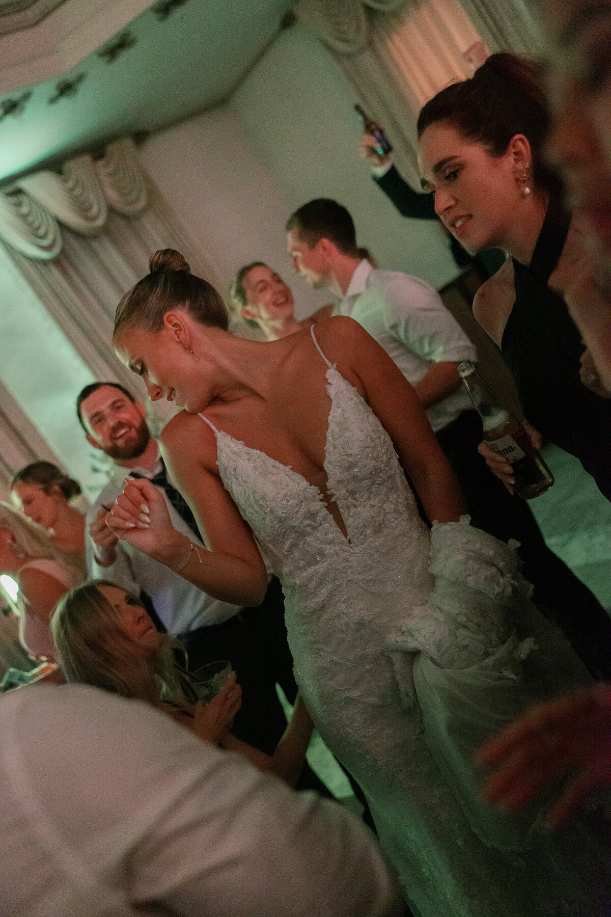 Bride dancing at reception surrounded by friends, captured by a wedding photographer in Philadelphia.