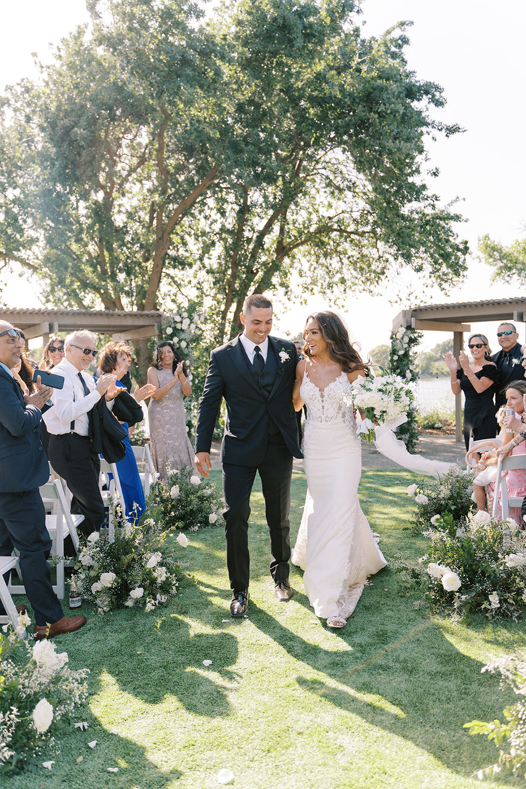 Bride and groom happy with white florals surrounding them