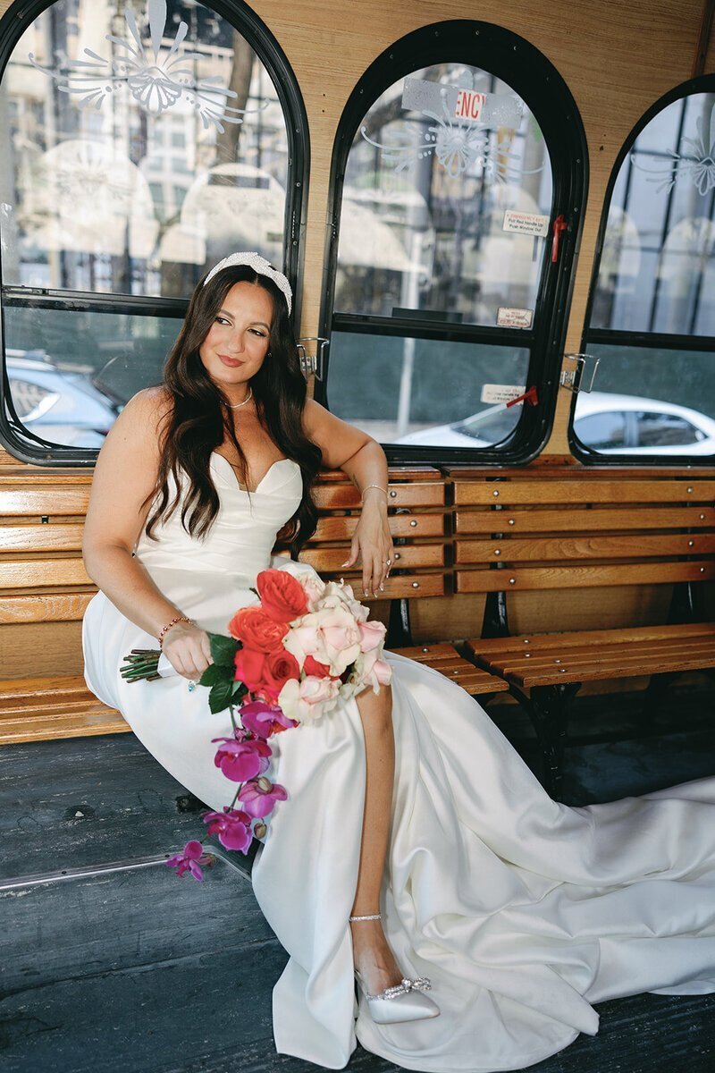 bride posing on bench in boat at penthouse at riverside wharf​