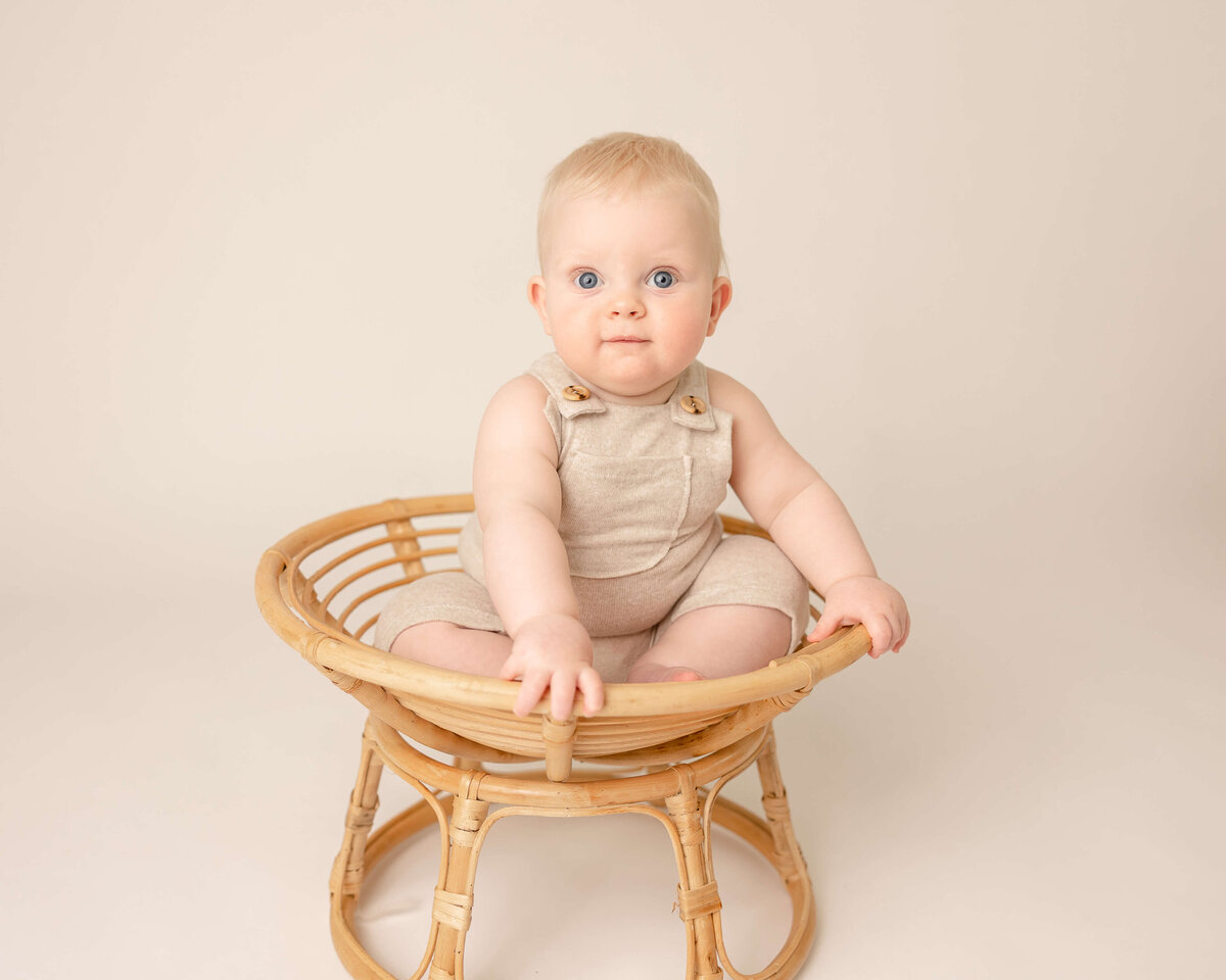 six month old baby boy in chair in portland milestone session