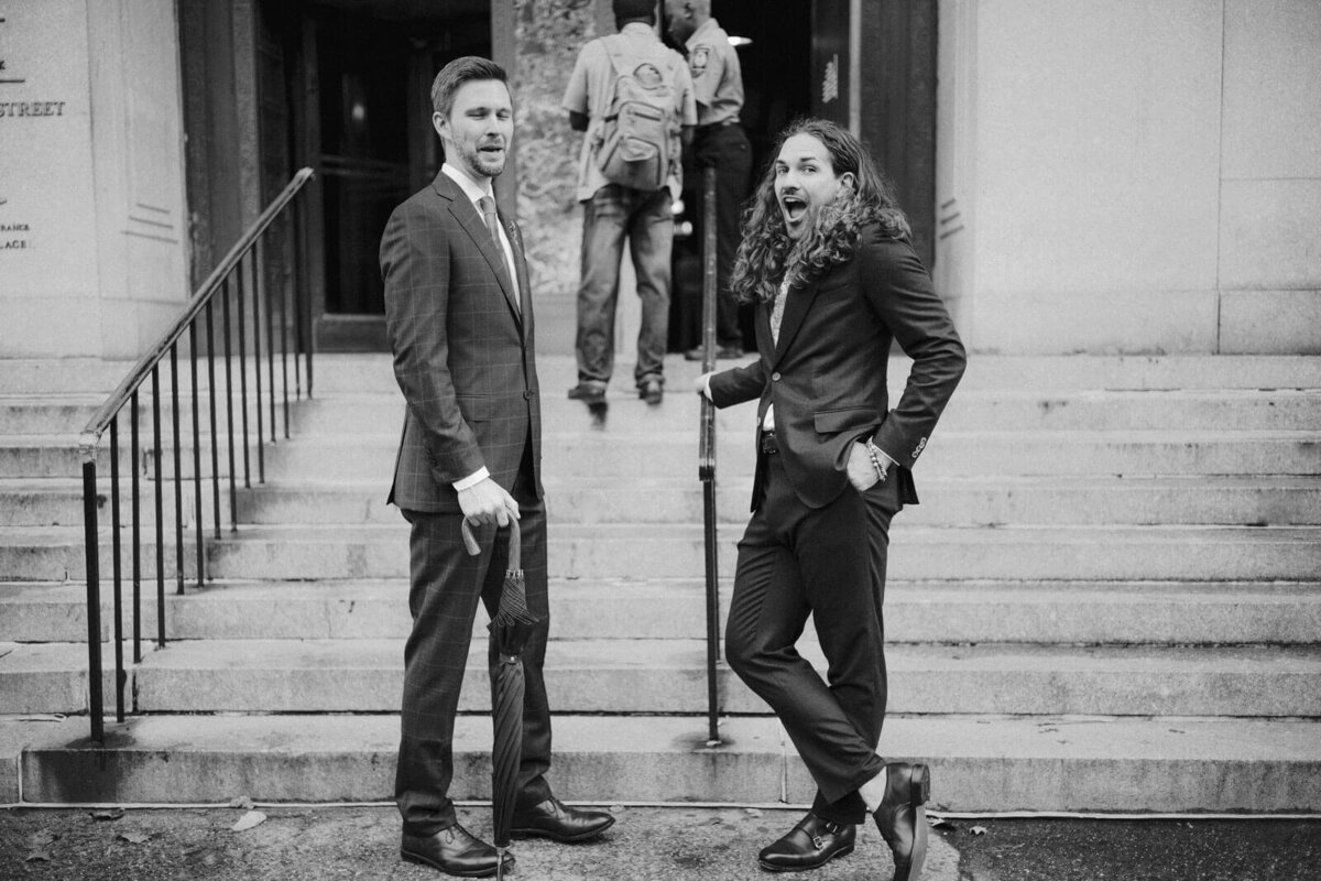 The two grooms pose to the camera before they enter the city clerk's office. NYC City Hall Elopement Image by Jenny Fu Studio