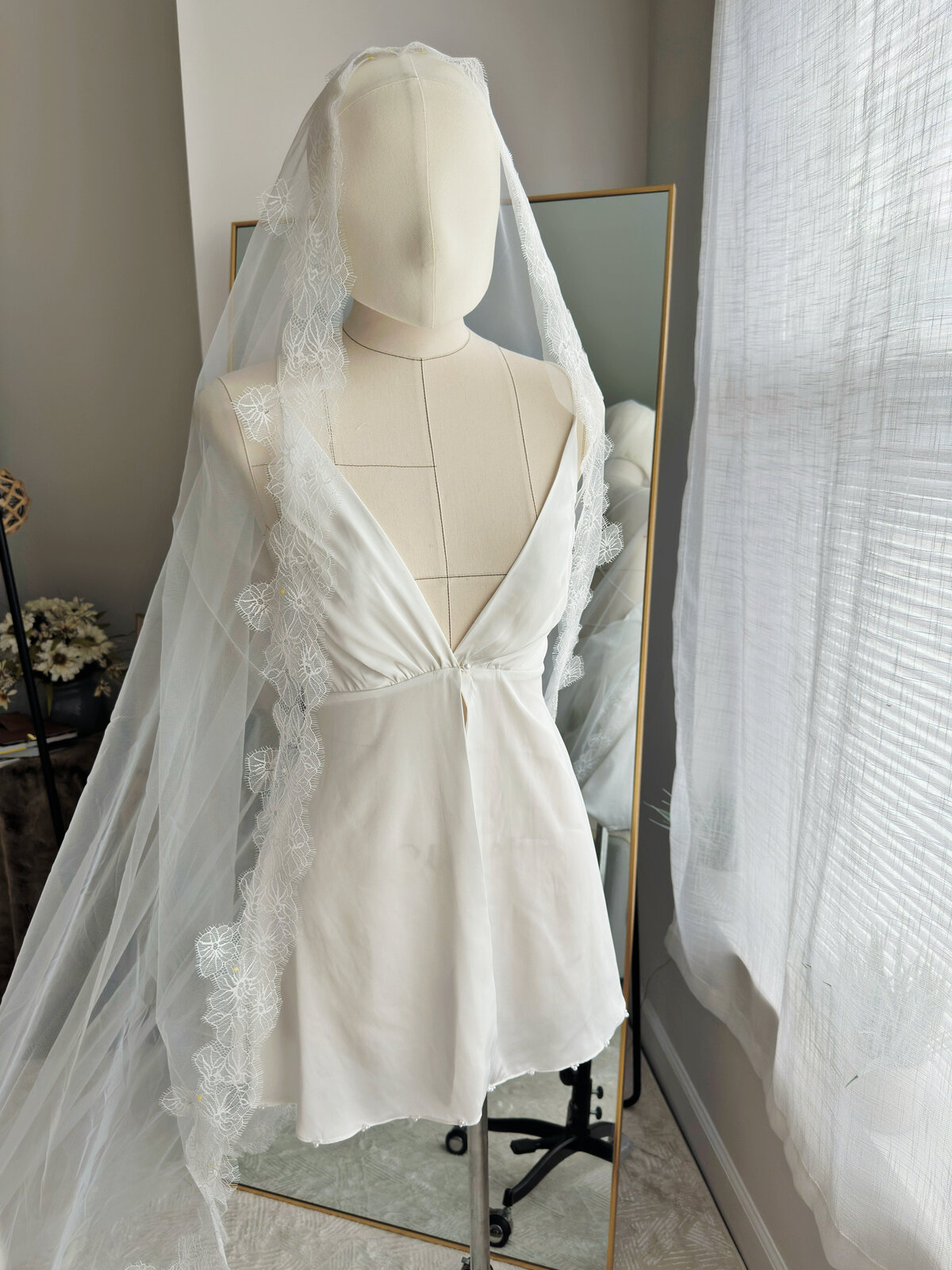 Elegant bridal mantilla veil with hand-embroidered lace edge
