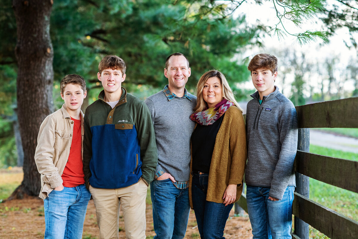 family standing near a fencce