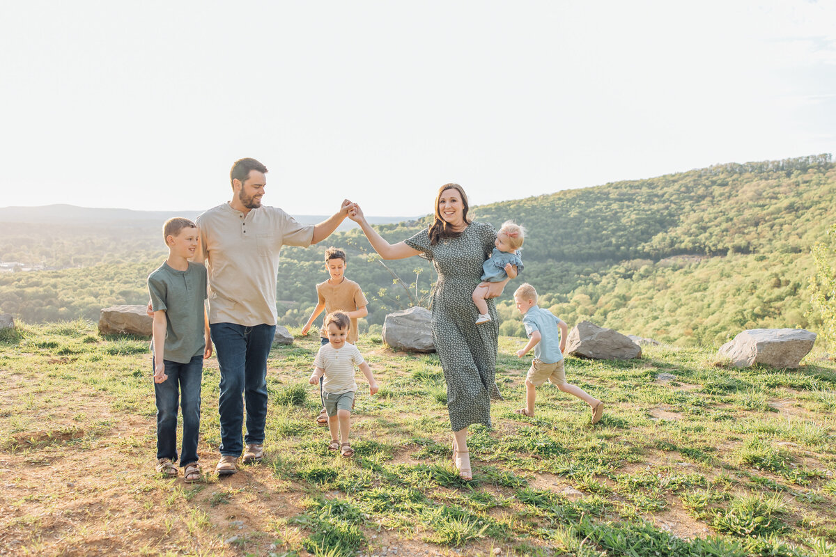 large family playing on a mountain