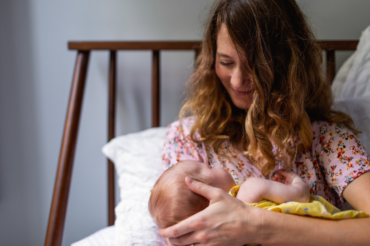 Mother cradling her sweet baby at home.